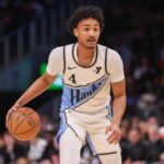 Atlanta Hawks guard Kobe Bufkin (4) dribbles against the Dallas Mavericks in the fourth quarter at State Farm Arena.