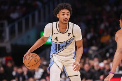Atlanta Hawks guard Kobe Bufkin (4) dribbles against the Dallas Mavericks in the fourth quarter at State Farm Arena.