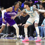 Jan 10, 2026; Salt Lake City, Utah, USA; Utah Jazz forward Cody Williams (5) looks to defend Charlotte Hornets guard LaMelo Ball (1) during the first half at Delta Center. Mandatory Credit: Peter Creveling-Imagn Images