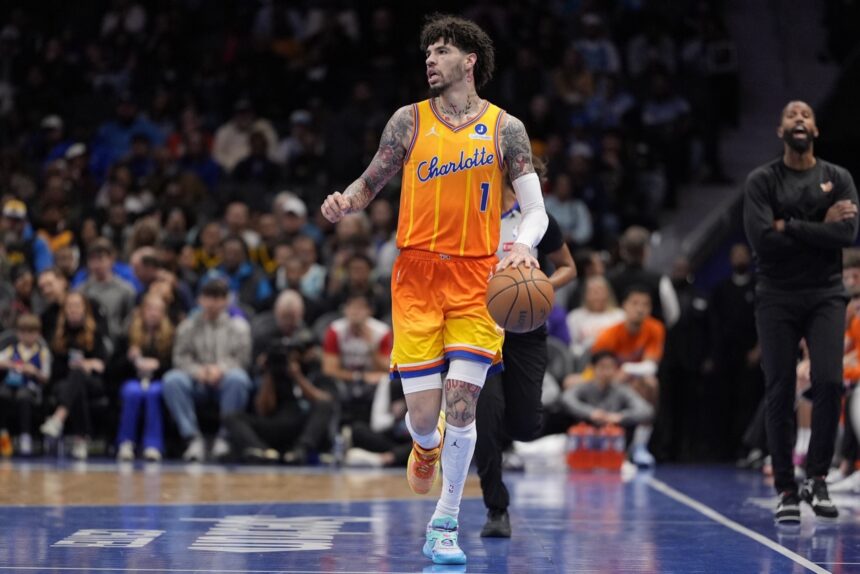 Dec 31, 2025; Charlotte, North Carolina, USA; Charlotte Hornets guard Lamelo Ball (1) brings the ball up court against the Golden State Warriors during the first quarter at Spectrum Center. Mandatory Credit: Jim Dedmon-Imagn Images