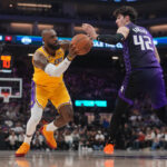 Jan 12, 2026; Sacramento, California, USA; Los Angeles Lakers forward LeBron James (23) drives to the hoop next to Sacramento Kings center Maxime Raynaud (42) in the second quarter at the Golden 1 Center. Mandatory Credit: Cary Edmondson-Imagn Images