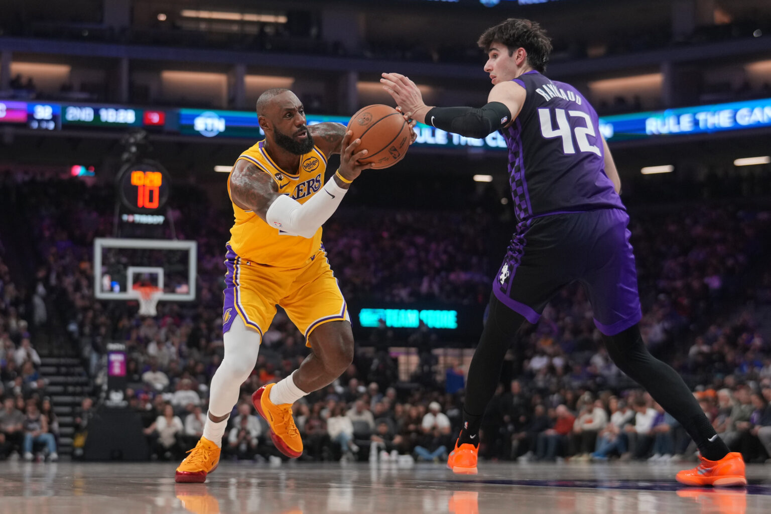 Jan 12, 2026; Sacramento, California, USA; Los Angeles Lakers forward LeBron James (23) drives to the hoop next to Sacramento Kings center Maxime Raynaud (42) in the second quarter at the Golden 1 Center. Mandatory Credit: Cary Edmondson-Imagn Images
