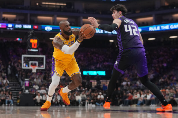 Jan 12, 2026; Sacramento, California, USA; Los Angeles Lakers forward LeBron James (23) drives to the hoop next to Sacramento Kings center Maxime Raynaud (42) in the second quarter at the Golden 1 Center. Mandatory Credit: Cary Edmondson-Imagn Images