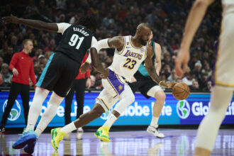 Jan 17, 2026; Portland, Oregon, USA; Los Angeles Lakers forward LeBron James (23) grabs the ball during the first half against Portland Trail Blazers guard Sidy Cissoko (91)at Moda Center. Mandatory Credit: Troy Wayrynen-Imagn Images