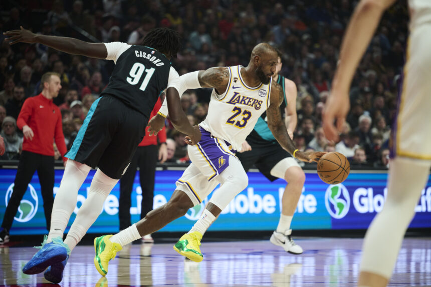 Jan 17, 2026; Portland, Oregon, USA; Los Angeles Lakers forward LeBron James (23) grabs the ball during the first half against Portland Trail Blazers guard Sidy Cissoko (91)at Moda Center. Mandatory Credit: Troy Wayrynen-Imagn Images