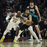 Jan 17, 2026; Portland, Oregon, USA; Los Angeles Lakers forward LeBron James (23) is fouled during the first half by Portland Trail Blazers forward Toumani Camara (33) at Moda Center. Mandatory Credit: Troy Wayrynen-Imagn Images