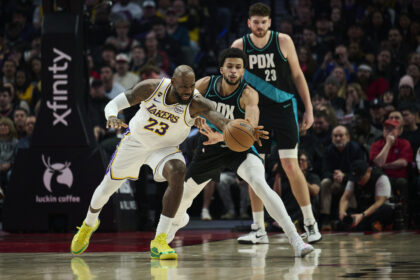 Jan 17, 2026; Portland, Oregon, USA; Los Angeles Lakers forward LeBron James (23) is fouled during the first half by Portland Trail Blazers forward Toumani Camara (33) at Moda Center. Mandatory Credit: Troy Wayrynen-Imagn Images