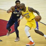 Jan 28, 2026; Cleveland, Ohio, USA; Cleveland Cavaliers guard Donovan Mitchell (45) defends Los Angeles Lakers forward LeBron James (23) in the fourth quarter at Rocket Arena. Mandatory Credit: David Richard-Imagn Images