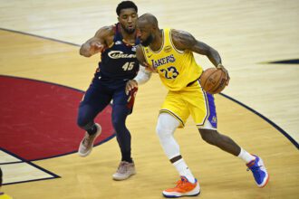 Jan 28, 2026; Cleveland, Ohio, USA; Cleveland Cavaliers guard Donovan Mitchell (45) defends Los Angeles Lakers forward LeBron James (23) in the fourth quarter at Rocket Arena. Mandatory Credit: David Richard-Imagn Images