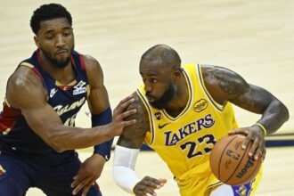Jan 28, 2026; Cleveland, Ohio, USA; Cleveland Cavaliers guard Donovan Mitchell (45) defends Los Angeles Lakers forward LeBron James (23) in the fourth quarter at Rocket Arena. Mandatory Credit: David Richard-Imagn Images