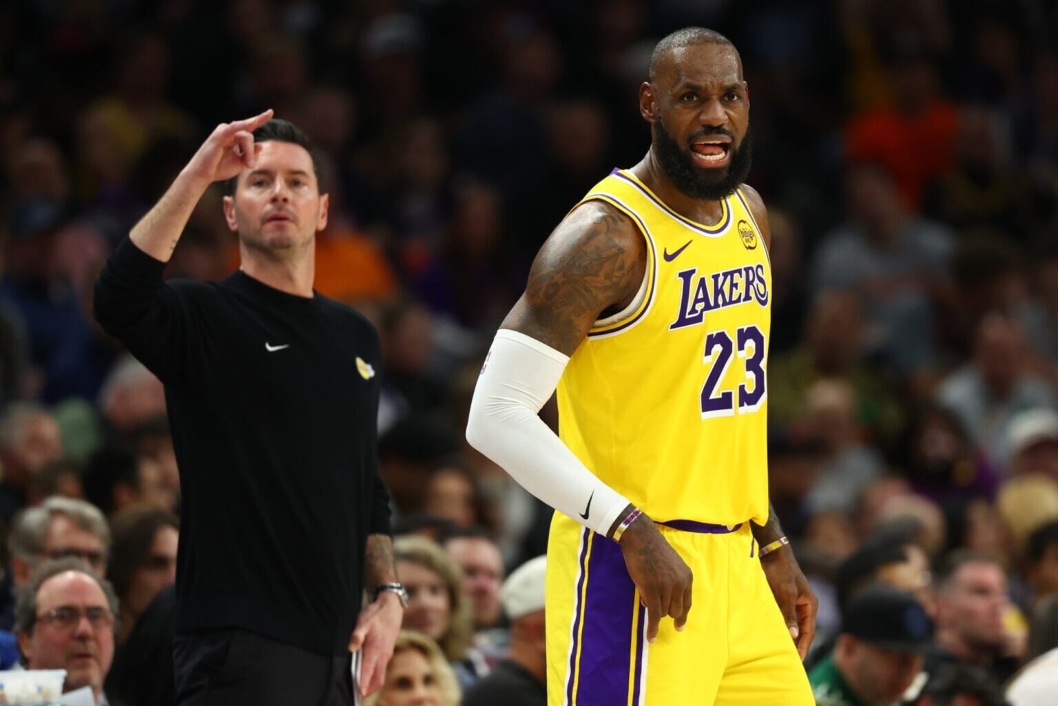 Dec 23, 2025; Phoenix, Arizona, USA; Los Angeles Lakers forward LeBron James (23) and head coach JJ Redick against the Phoenix Suns in the first half at Mortgage Matchup Center. Mandatory Credit: Mark J. Rebilas-Imagn Images