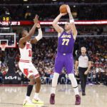Jan 26, 2026; Chicago, Illinois, USA; Los Angeles Lakers guard Luka Doncic (77) shoots against Chicago Bulls guard Ayo Dosunmu (11) during the second half at United Center. Mandatory Credit: Kamil Krzaczynski-Imagn Images