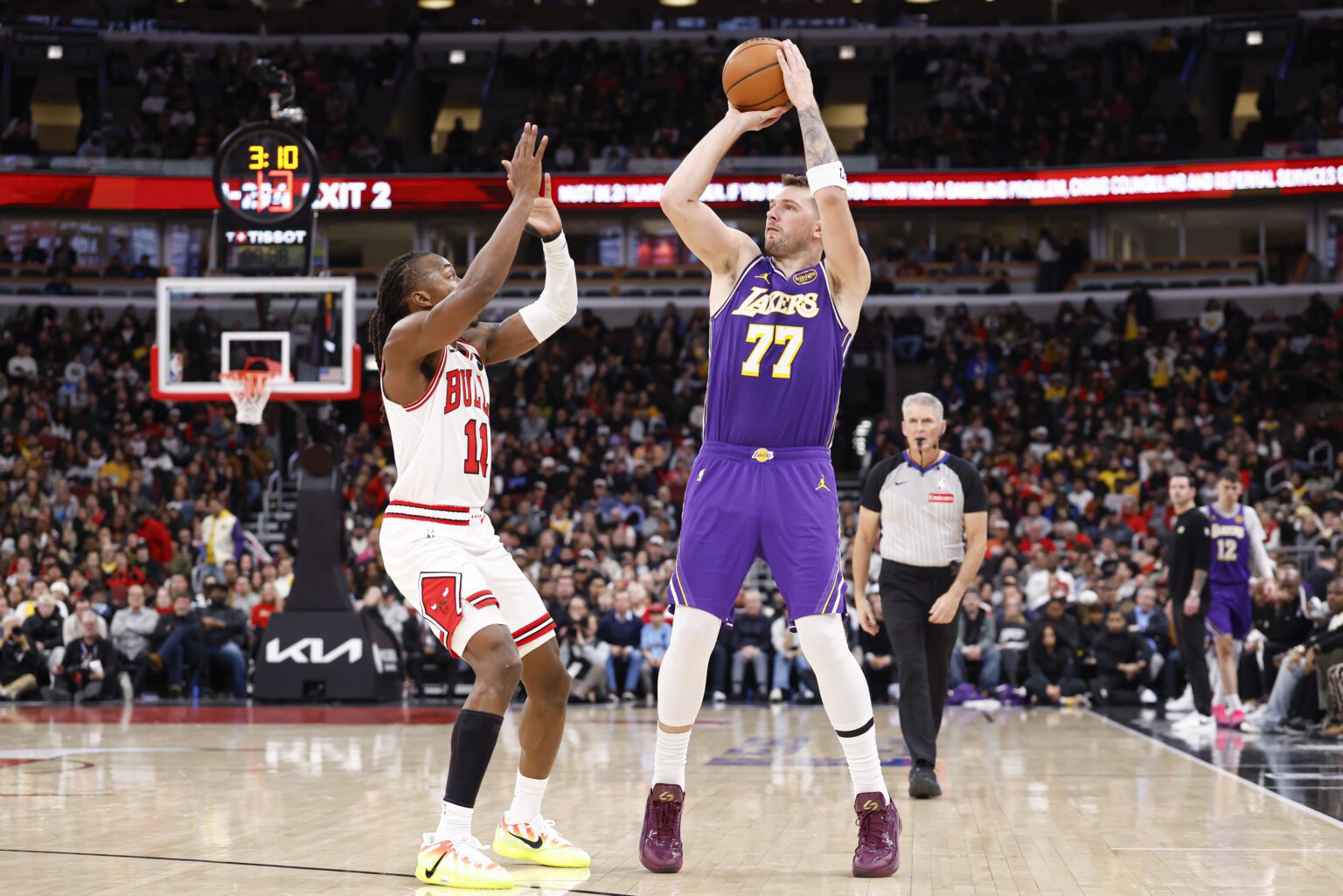 Jan 26, 2026; Chicago, Illinois, USA; Los Angeles Lakers guard Luka Doncic (77) shoots against Chicago Bulls guard Ayo Dosunmu (11) during the second half at United Center. Mandatory Credit: Kamil Krzaczynski-Imagn Images