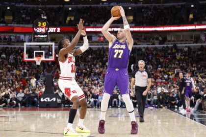 Jan 26, 2026; Chicago, Illinois, USA; Los Angeles Lakers guard Luka Doncic (77) shoots against Chicago Bulls guard Ayo Dosunmu (11) during the second half at United Center. Mandatory Credit: Kamil Krzaczynski-Imagn Images