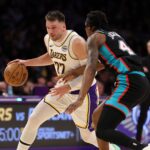 Jan 4, 2026; Los Angeles, California, USA; Los Angeles Lakers forward/guard Luka Doncic (77) dribbles the ball against Memphis Grizzlies forward GG Jackson (45) during the first quarter at Crypto.com Arena. Mandatory Credit: Kiyoshi Mio-Imagn Images