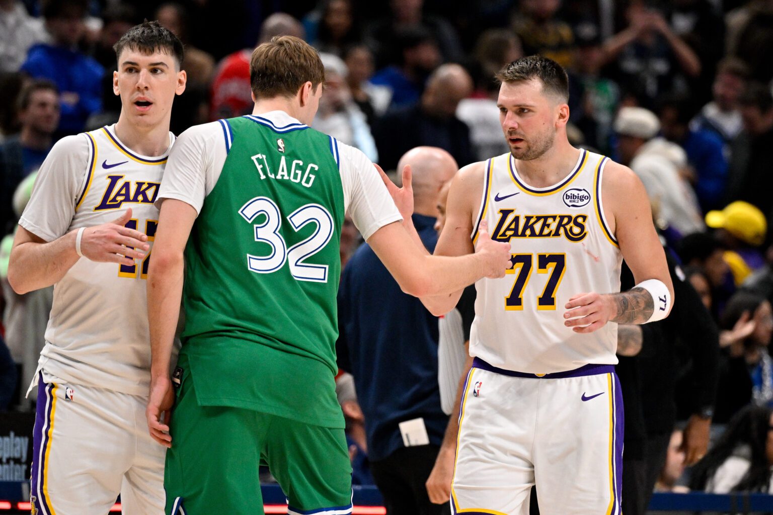 Jan 24, 2026; Dallas, Texas, USA; Dallas Mavericks forward Cooper Flagg (32) and Los Angeles Lakers guard Luka Doncic (77) exchange words after the game at the American Airlines Center. Mandatory Credit: Jerome Miron-Imagn Images