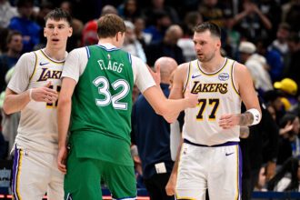 Jan 24, 2026; Dallas, Texas, USA; Dallas Mavericks forward Cooper Flagg (32) and Los Angeles Lakers guard Luka Doncic (77) exchange words after the game at the American Airlines Center. Mandatory Credit: Jerome Miron-Imagn Images