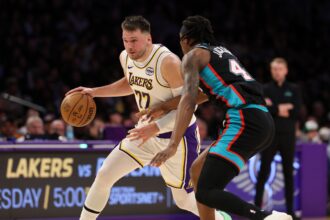 Jan 4, 2026; Los Angeles, California, USA; Los Angeles Lakers forward/guard Luka Doncic (77) dribbles the ball against Memphis Grizzlies forward GG Jackson (45) during the first quarter at Crypto.com Arena. Mandatory Credit: Kiyoshi Mio-Imagn Images