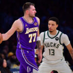 Jan 9, 2026; Los Angeles, California, USA; Los Angeles Lakers guard Luka Doncic (77) moves the ball against Milwaukee Bucks guard Ryan Rollins (13) during the first half at Crypto.com Arena. Mandatory Credit: Gary A. Vasquez-Imagn Images
