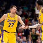 Jan 6, 2026; New Orleans, Louisiana, USA; Los Angeles Lakers forward/guard Luka Doncic (77) slaps hands with center Deandre Ayton (5) after a play against the New Orleans Pelicans during the second half at Smoothie King Center. Mandatory Credit: Stephen Lew-Imagn Images