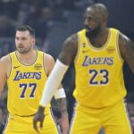 Jan 28, 2026; Cleveland, Ohio, USA; Los Angeles Lakers guard Luka Doncic (77) and forward LeBron James (23) stand on the court in the first quarter against the Cleveland Cavaliers at Rocket Arena. Mandatory Credit: David Richard-Imagn Images