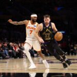 Jan 13, 2026; Los Angeles, California, USA; Los Angeles Lakers guard Luka Doncic (77) drives to the basket against Atlanta Hawks guard Nickeil Alexander-Walker (7) during the fourth quarter at Crypto.com Arena. Mandatory Credit: Kiyoshi Mio-Imagn Images