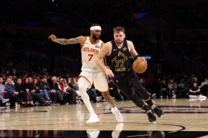 Jan 13, 2026; Los Angeles, California, USA; Los Angeles Lakers guard Luka Doncic (77) drives to the basket against Atlanta Hawks guard Nickeil Alexander-Walker (7) during the fourth quarter at Crypto.com Arena. Mandatory Credit: Kiyoshi Mio-Imagn Images