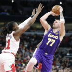 Jan 26, 2026; Chicago, Illinois, USA; Los Angeles Lakers guard Luka Doncic (77) shoots against Chicago Bulls guard Ayo Dosunmu (11) during the second half at United Center. Mandatory Credit: Kamil Krzaczynski-Imagn Images