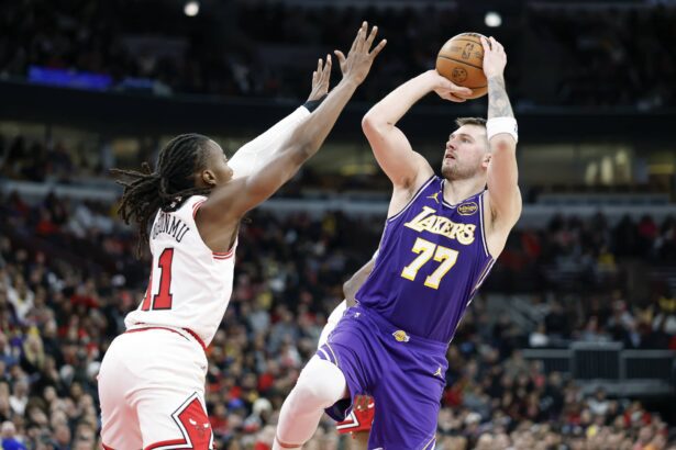 Jan 26, 2026; Chicago, Illinois, USA; Los Angeles Lakers guard Luka Doncic (77) shoots against Chicago Bulls guard Ayo Dosunmu (11) during the second half at United Center. Mandatory Credit: Kamil Krzaczynski-Imagn Images