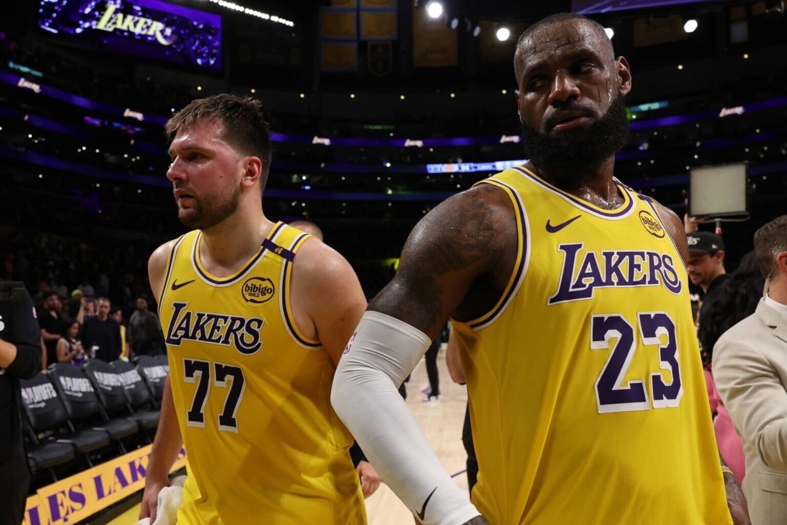 Apr 22, 2025; Los Angeles, California, USA; Los Angeles Lakers guard Luka Doncic (77) and Los Angeles Lakers forward LeBron James (23) leave a court after defeating the Minnesota Timberwolves 94-85 in game two of first round for the 2024 NBA Playoffs at Crypto.com Arena. Mandatory Credit: Kiyoshi Mio-Imagn Images