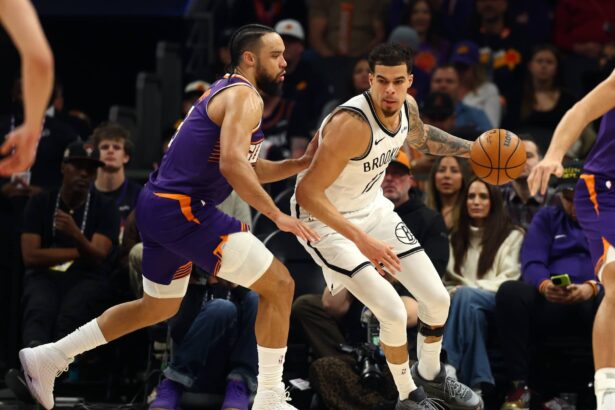 Jan 27, 2026; Phoenix, Arizona, USA; Brooklyn Nets forward Michael Porter Jr. (17) against Phoenix Suns forward Dillon Brooks (3) in the first half at Mortgage Matchup Center. Mandatory Credit: Mark J. Rebilas-Imagn Images