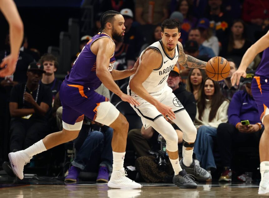 Jan 27, 2026; Phoenix, Arizona, USA; Brooklyn Nets forward Michael Porter Jr. (17) against Phoenix Suns forward Dillon Brooks (3) in the first half at Mortgage Matchup Center. Mandatory Credit: Mark J. Rebilas-Imagn Images