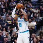 Jan 18, 2026; Denver, Colorado, USA; Charlotte Hornets forward Miles Bridges (0) shoots in the first quarter against the Denver Nuggets at Ball Arena. Mandatory Credit: Ron Chenoy-Imagn Images