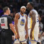 Golden State Warriors forward Draymond Green (23) reacts to a call with referee Andy Nagy (83) with guard Moses Moody (4) listening in during the second quarter against the Charlotte Hornets at Spectrum Center.