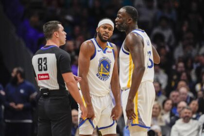 Golden State Warriors forward Draymond Green (23) reacts to a call with referee Andy Nagy (83) with guard Moses Moody (4) listening in during the second quarter against the Charlotte Hornets at Spectrum Center.