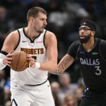 Dec 23, 2025; Dallas, Texas, USA; Denver Nuggets center Nikola Jokic (15) looks to move the ball past Dallas Mavericks forward Anthony Davis (3) during the second half at the American Airlines Center. Mandatory Credit: Jerome Miron-Imagn Images