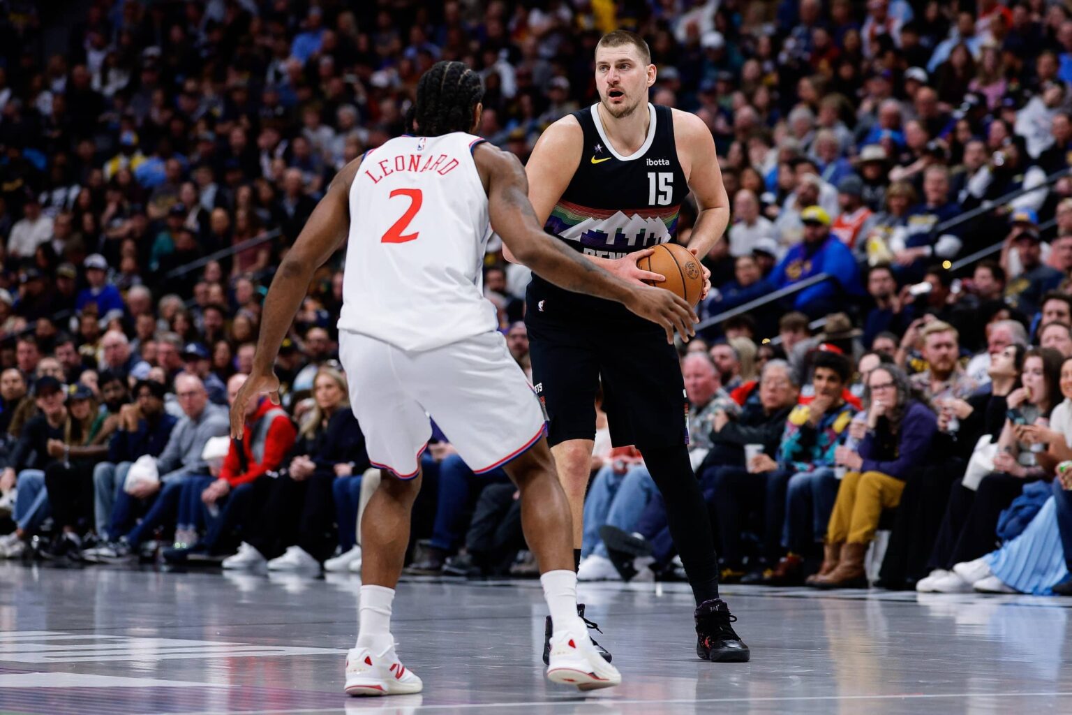 Jan 30, 2026; Denver, Colorado, USA; Denver Nuggets center Nikola Jokic (15) controls the ball as Los Angeles Clippers forward Kawhi Leonard (2) guards in the third quarter at Ball Arena. Mandatory Credit: Isaiah J. Downing-Imagn Images