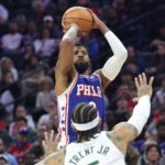 Jan 27, 2026; Philadelphia, Pennsylvania, USA; Philadelphia 76ers forward Paul George (8) shoots in front of Milwaukee Bucks guard Gary Trent Jr. (5) during the fourth quarter at Xfinity Mobile Arena. Mandatory Credit: Bill Streicher-Imagn Images
