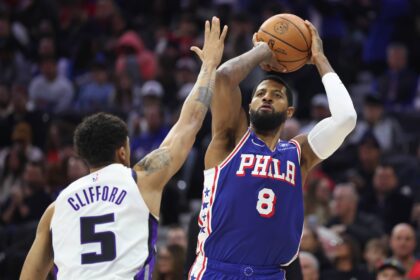 Jan 29, 2026; Philadelphia, Pennsylvania, USA; Philadelphia 76ers forward Paul George (8) shoots in front of Sacramento Kings guard Nique Clifford (5) during the third quarter at Xfinity Mobile Arena. Mandatory Credit: Bill Streicher-Imagn Images