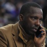 NBA agent Rich Paul talks on the phone prior to the game between the Charlotte Hornets and Philadelphia 76ers at the Wells Fargo Center.