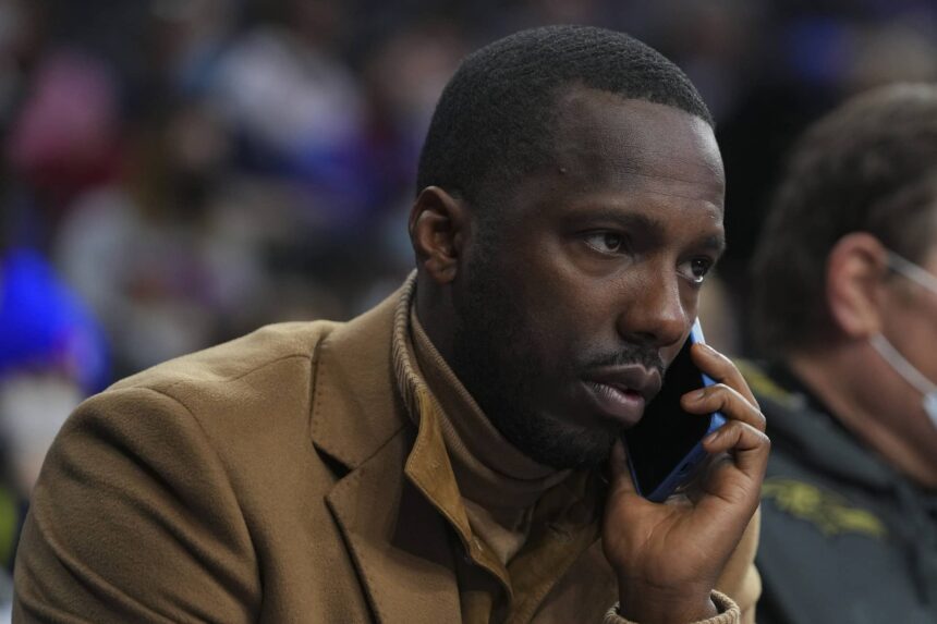 NBA agent Rich Paul talks on the phone prior to the game between the Charlotte Hornets and Philadelphia 76ers at the Wells Fargo Center.
