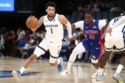 Oct 6, 2025; Memphis, Tennessee, USA; Memphis Grizzlies guard Scotty Pippen Jr. (1) dribbles around a screen set by forward Olivier-Maxence Prosper (18) on Detroit Pistons guard Javonte Green (31) during the fourth quarter at FedExForum. Mandatory Credit: Petre Thomas-Imagn Images