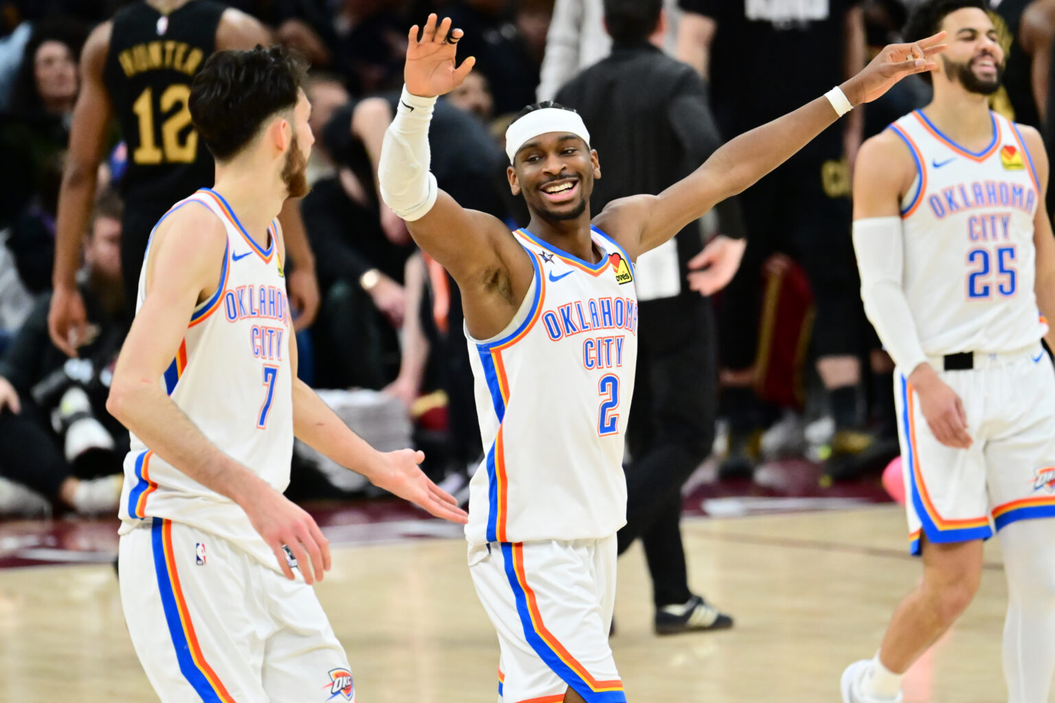 Jan 19, 2026; Cleveland, Ohio, USA; Oklahoma City Thunder guard Luguentz Dort (5) and center Chet Holmgren (7) celebrate after a three point basket during the second half against the Cleveland Cavaliers at Rocket Arena. Mandatory Credit: Ken Blaze-Imagn Images