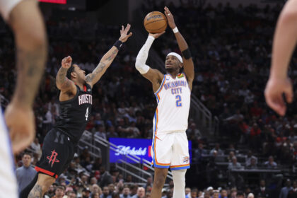 Jan 15, 2026; Houston, Texas, USA; Oklahoma City Thunder guard Shai Gilgeous-Alexander (2) shoots the ball as Houston Rockets guard JD Davison (4) defends during the third quarter at Toyota Center. Mandatory Credit: Troy Taormina-Imagn Images