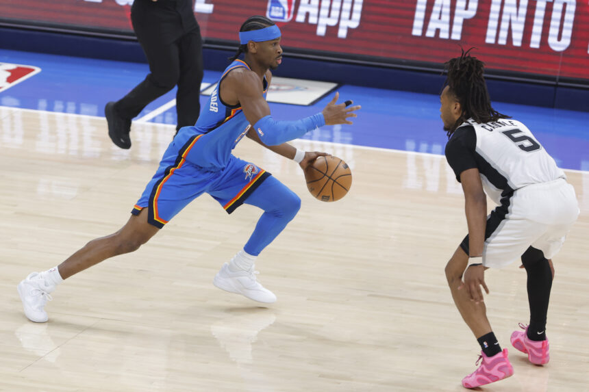 Jan 13, 2026; Oklahoma City, Oklahoma, USA; Oklahoma City Thunder guard Shai Gilgeous-Alexander (2) drives down the court as San Antonio Spurs guard Stephon Castle (5) defends during the first quarter at Paycom Center. Mandatory Credit: Alonzo Adams-Imagn Images