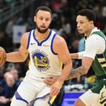 Golden State Warriors guard Stephen Curry (30) looks for a shot against Milwaukee Bucks guard Ryan Rollins (13) in the first quarter at Fiserv Forum.