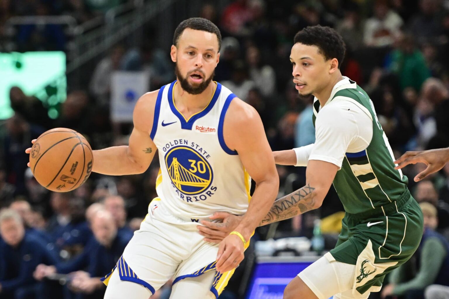 Golden State Warriors guard Stephen Curry (30) looks for a shot against Milwaukee Bucks guard Ryan Rollins (13) in the first quarter at Fiserv Forum.