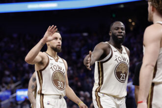 Jan 9, 2026; San Francisco, California, USA; Golden State Warriors guard Stephen Curry (30) and forward Draymond Green (23) high five guard Brandin Podziemski (2) after a play against the Sacramento Kings during the fourth quarter at Chase Center. Mandatory Credit: Kelley L Cox-Imagn Images