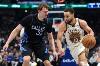 Jan 22, 2026; Dallas, Texas, USA; Golden State Warriors guard Stephen Curry (30) drives to the basket as Dallas Mavericks forward Cooper Flagg (32) defends during the first half at American Airlines Center. Mandatory Credit: Kevin Jairaj-Imagn Images
