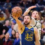 Jan 7, 2026; San Francisco, California, USA; Golden State Warriors guard Stephen Curry (30) shoots the ball against Milwaukee Bucks guard Ryan Rollins (13) during the fourth quarter at Chase Center. Mandatory Credit: Robert Edwards-Imagn Images